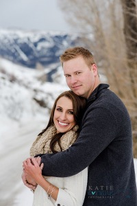Couple hugging in snowy, wintery, mountain engagements in Dillon, CO
